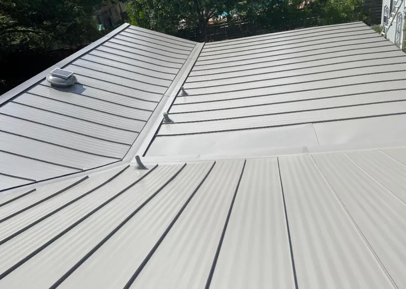 Solar attic fan installed on a metal roof for Roof Ventilation in Maine
